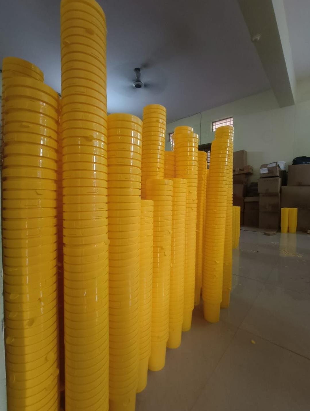 Tall stacks of yellow pheromone trap funnels in the Agri Phero Solutionz warehouse, Hyderabad